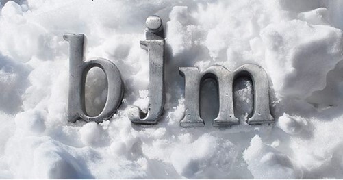 bjm in gray letters with snow in the background.